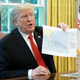 Donald Trump holding hurricane projection map